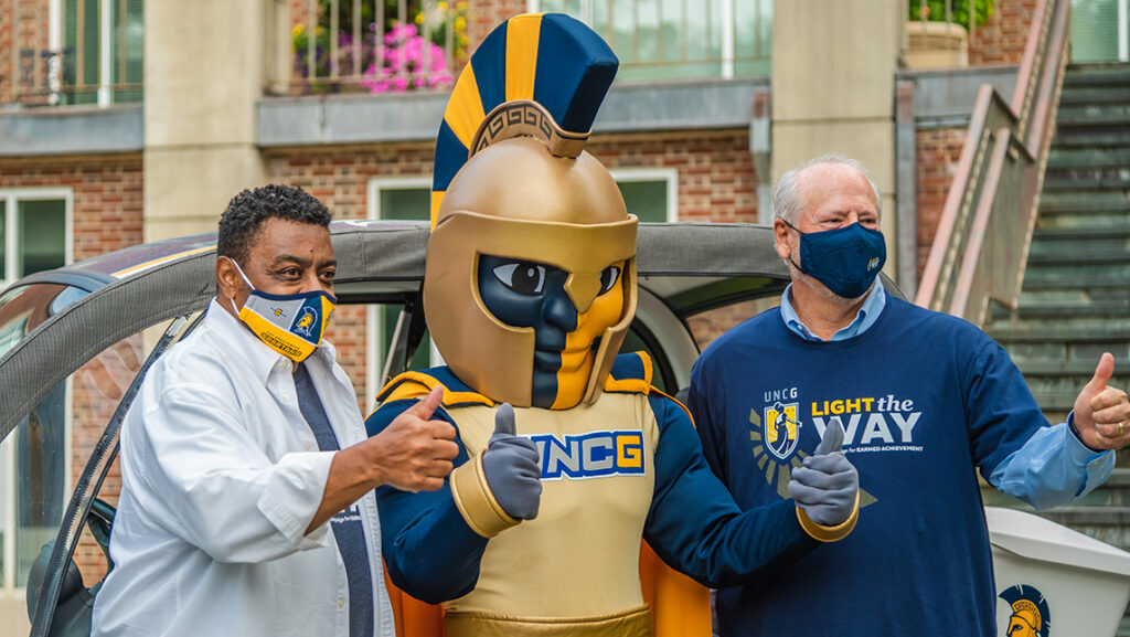 two men with Spartan mascot