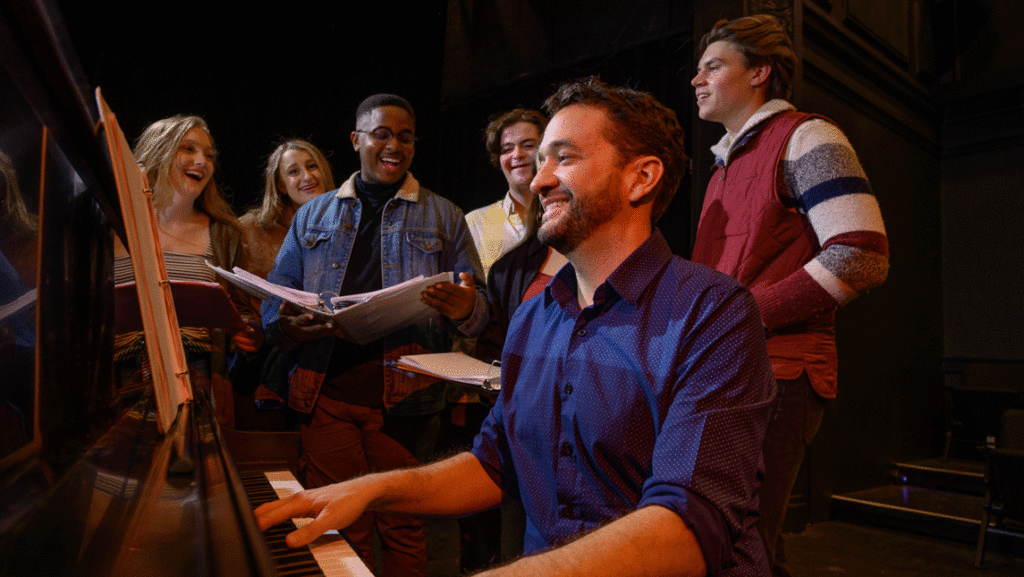 man with piano and students