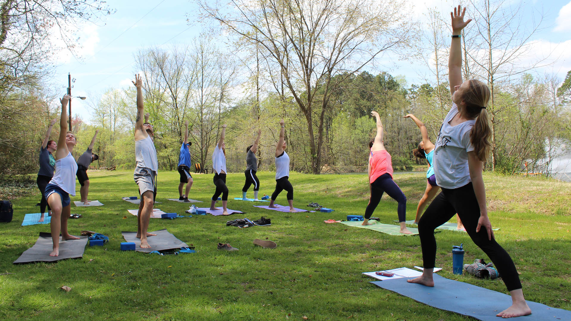 UNCG students practice yoga at Piney Lake to help center themselves and exercise.