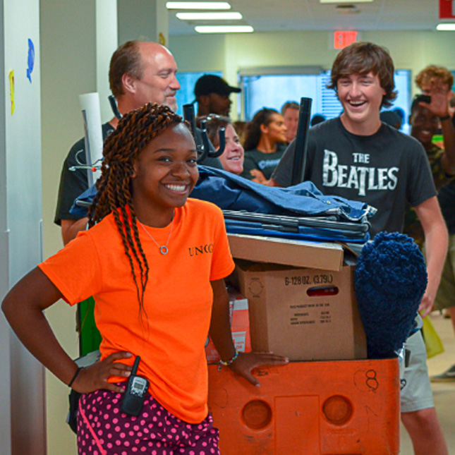 Students move boxes into residence halls on move-in day.