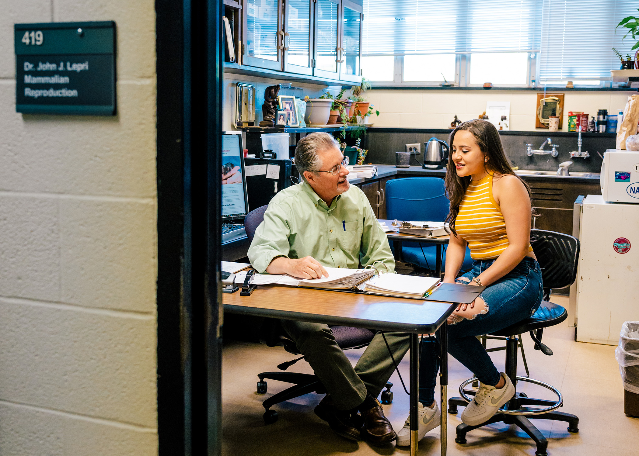 A peek into an advisor's office while he meets with a student.