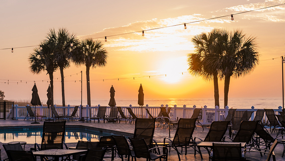 A sunset over a beach resort.