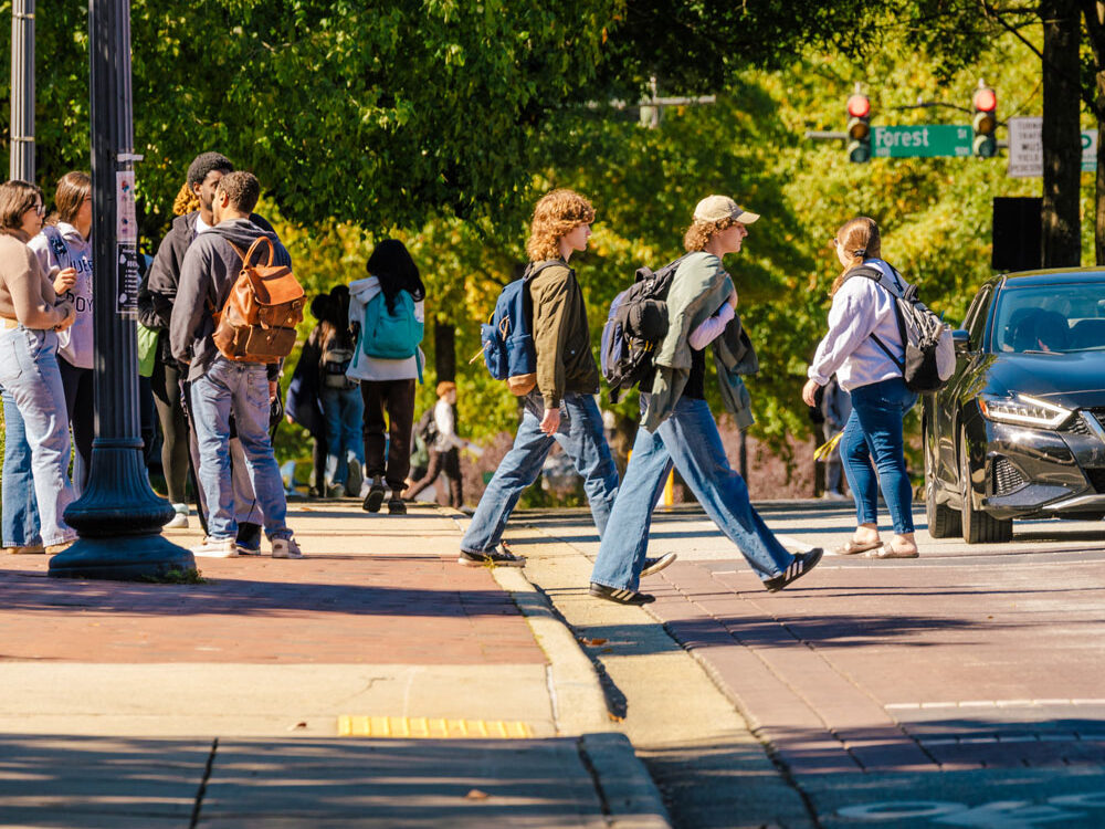 A vast array of students walk across Spring Garden Street.