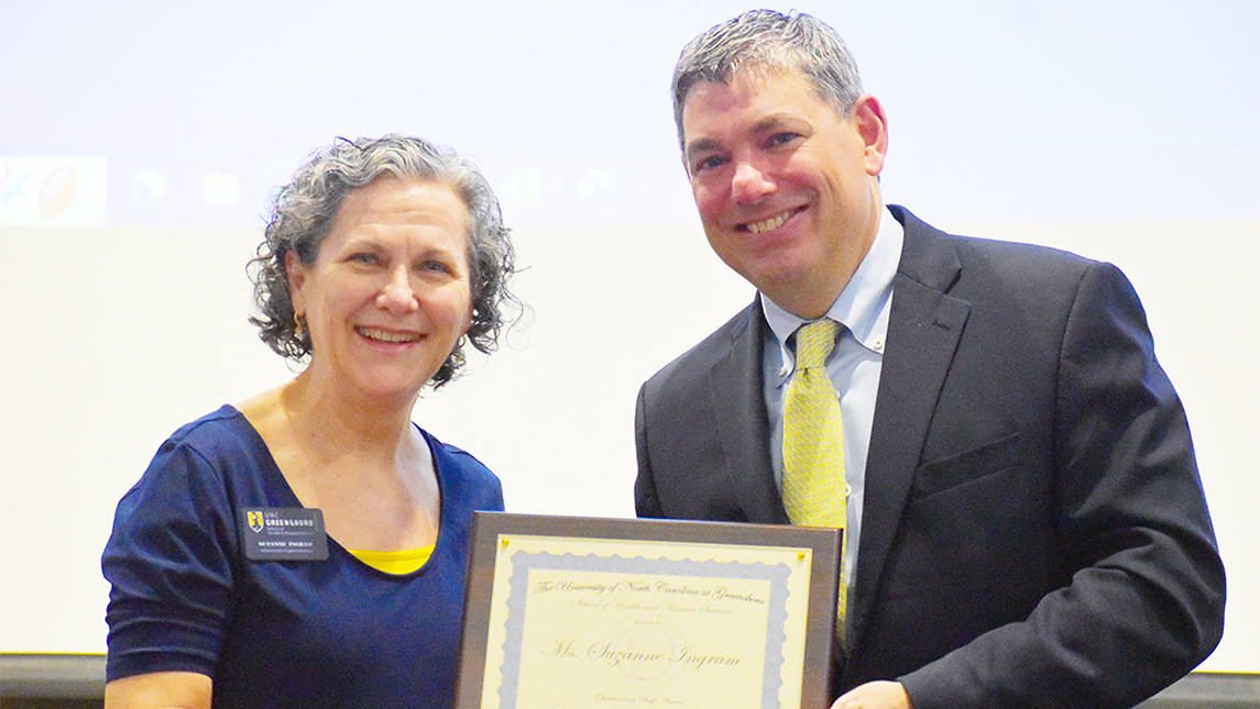 UNCG Dean Carl Mattacola gives an award certificate to Suzanne Ingram.