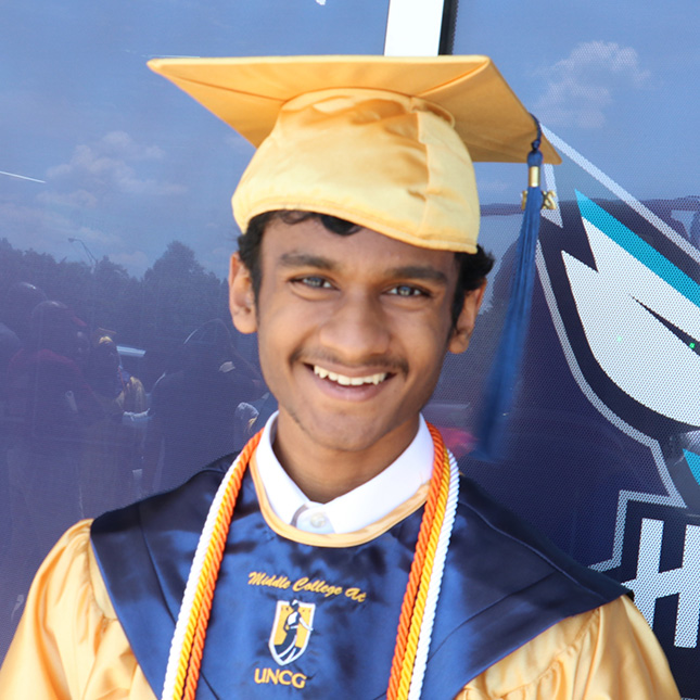 Headshot of a student in a yellow cap and gown with Middle College at UNCG on the sash.