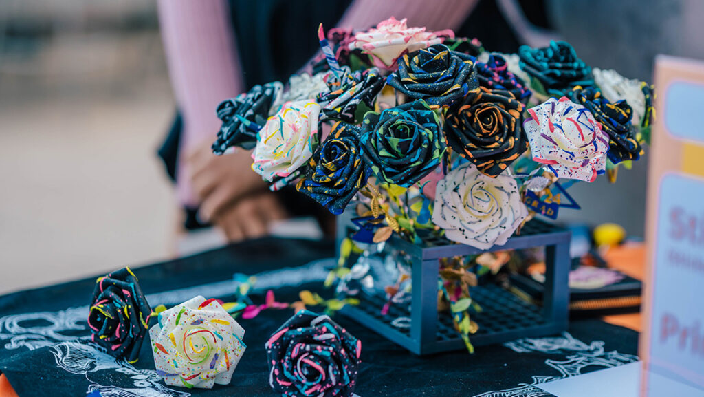A UNCG student's fabric flowers sit on a table for sale.