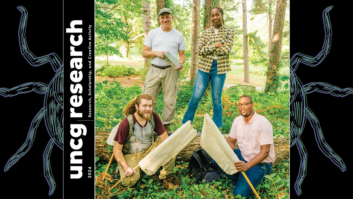 Dr. Gideon Wasserberg stands in the woods with three of his UNCG students holding nets.