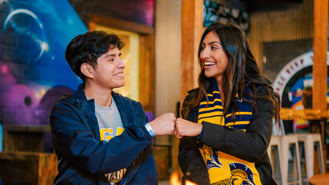 UNCG students fistbump on the patio at Southend Brewery.