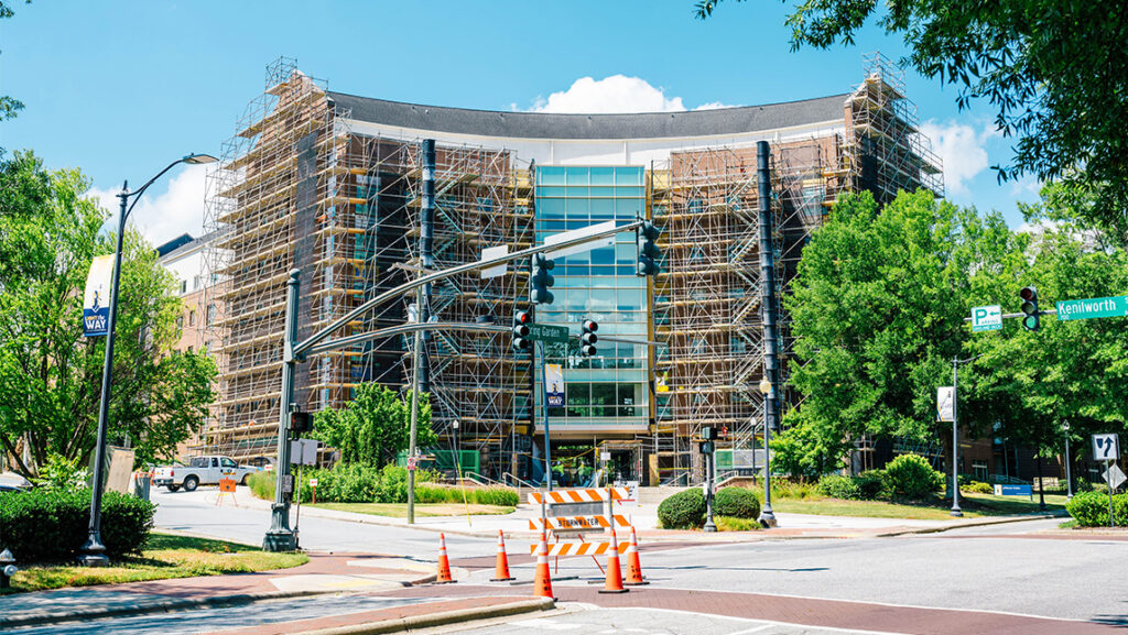 Scaffolding covers the UNCG Jefferson Suites building.