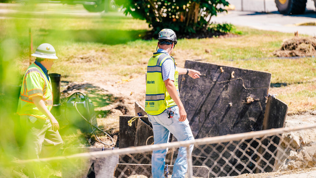 A construction worker examines debris from a UNCG project.