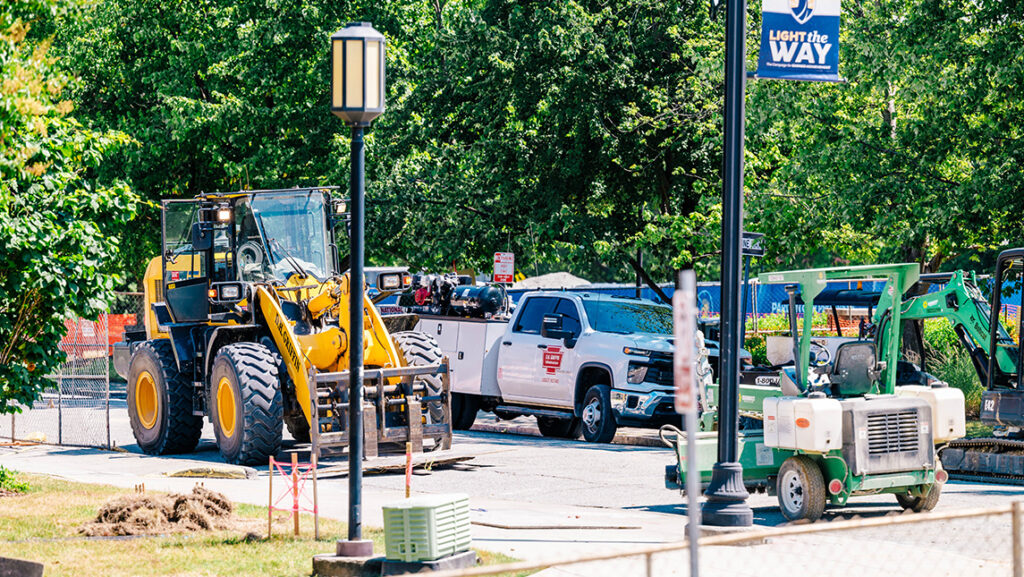 Trucks and construction vehicles line the street at UNCG.