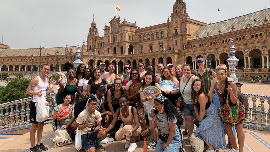 A crowd of UNCG students have a group picture in Spain.