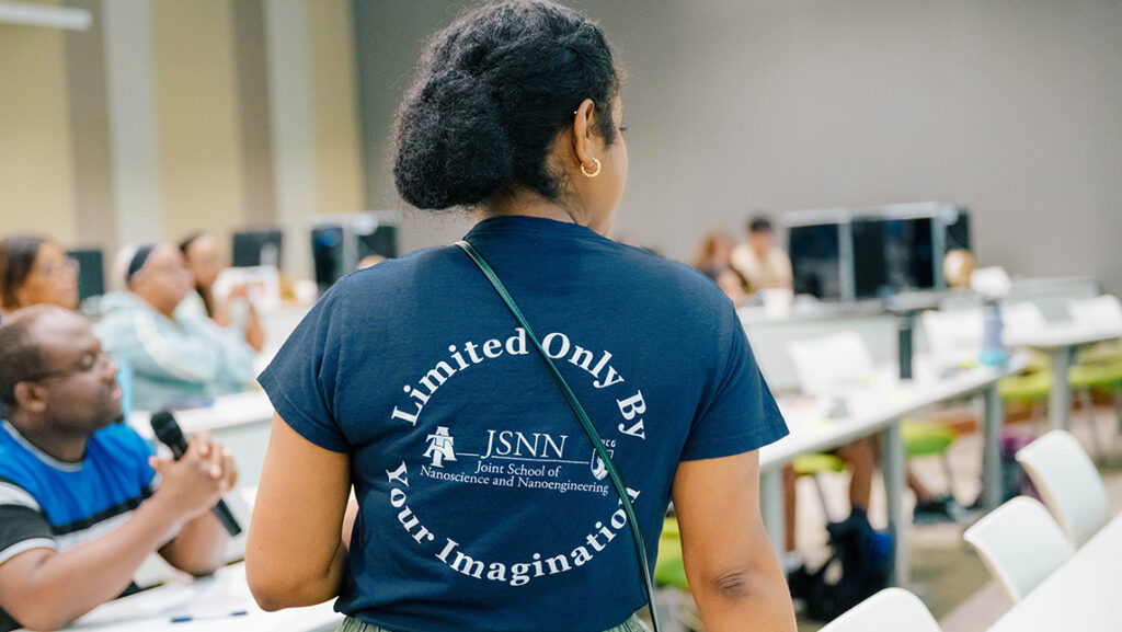 Dr. Chartanay Bonner wears a JSNN-themed shirt reading "Limited only by your imagination."