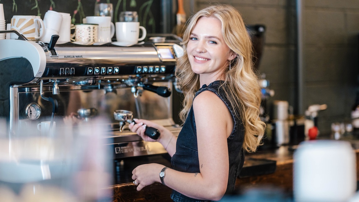 Leah Zubke, Bryan School alum preparing coffee at her shop, Ardmore Coffee.