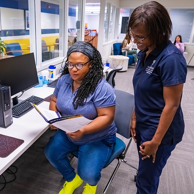 Career coach helps a student at CPD office.