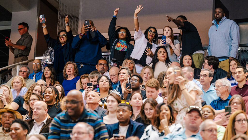 Family members cheer at the UNCG Commencement.