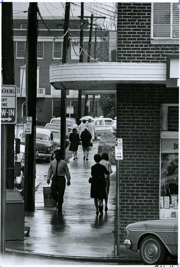 Students walk toward Tate Street in a black and white photo.