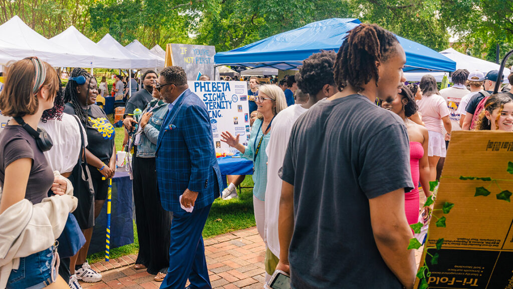 UNCG Chancellor Gilliam and students talk at the Fall Festival.