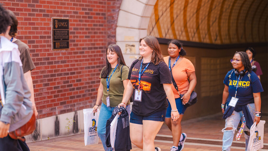 Students walk through the Gate City tunnel to UNCG campus.