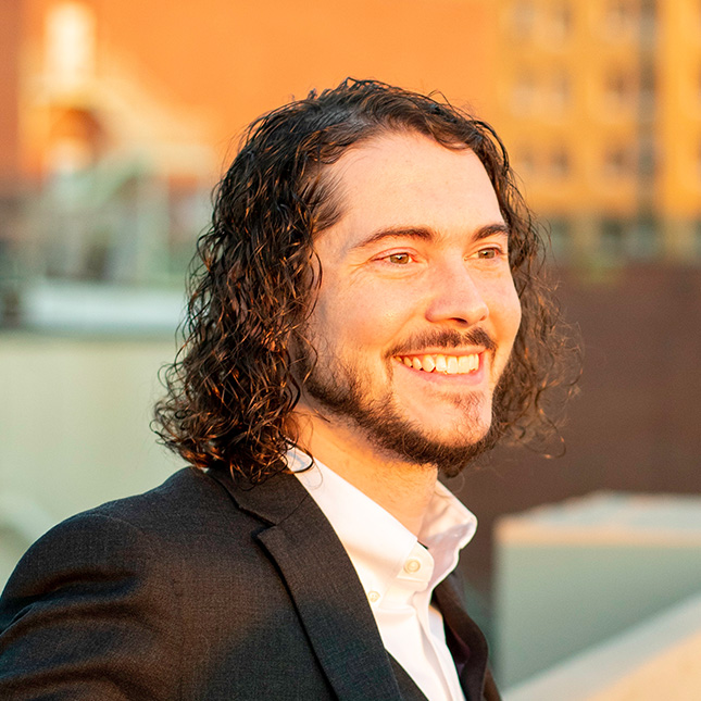 Student headshot with an urban background.