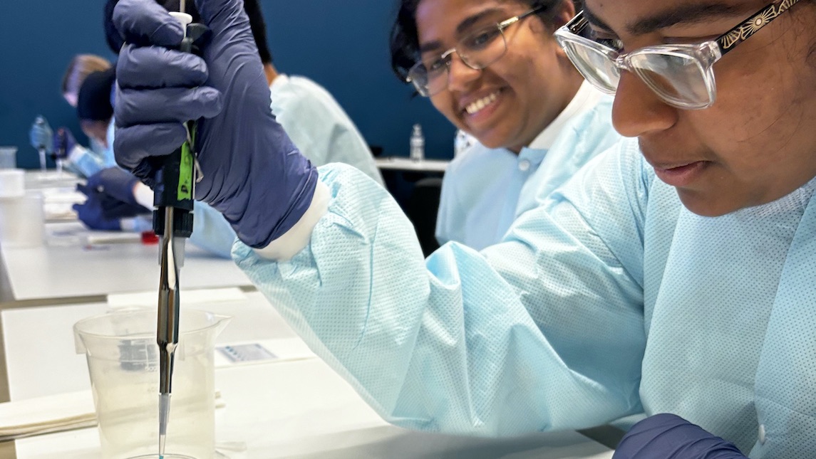 Two female high school students in the JSNN lab working.