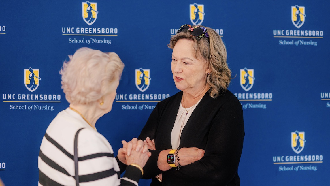 Dr. Robin Bartlett speaking with an attendee.