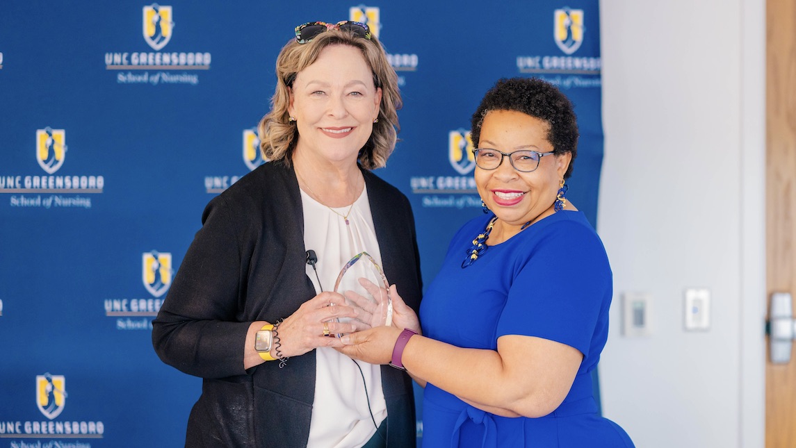 Dr. Barksdale presenting Alumni award to Dr. Robin Bartlett at UNCG School of Nursing.