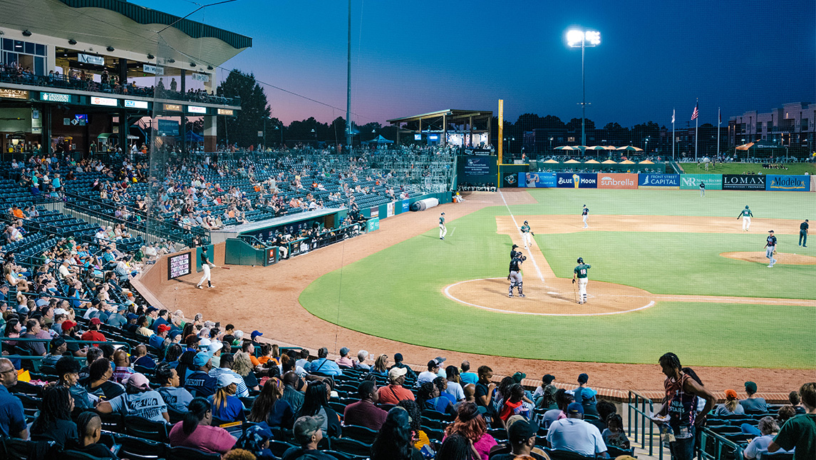 Baseball players on the diamond during a UNCG Night at the Grasshoppers.