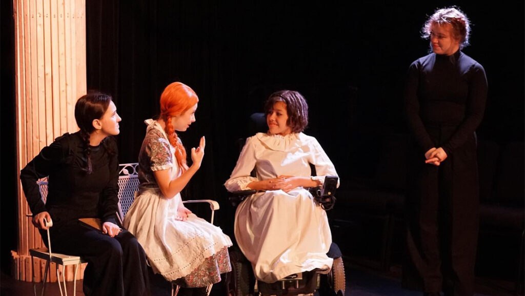 Actresses in Anne of Green Gables talk while their sign language interpreters stand next to them.