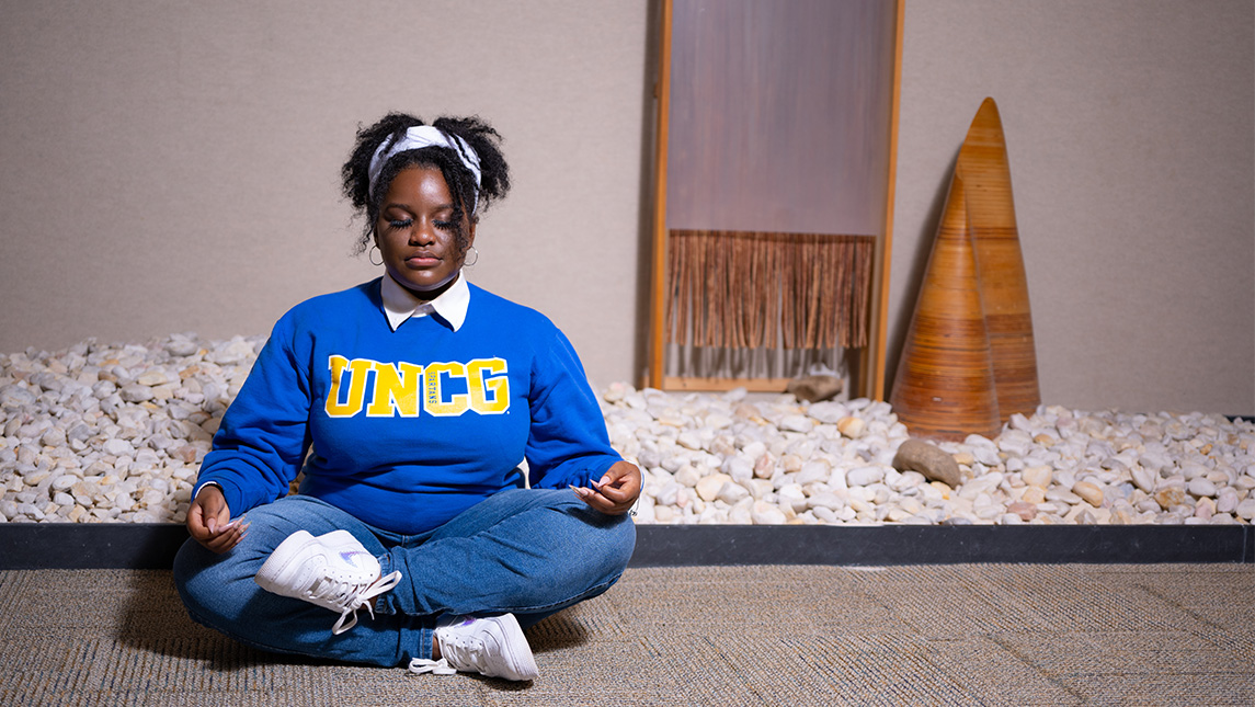 A UNCG student meditates.