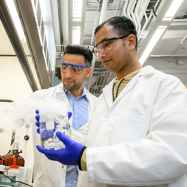 Two students work in a lab.