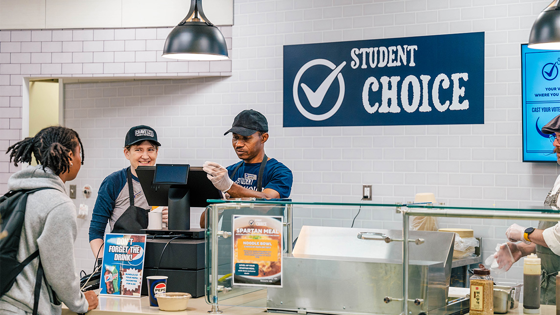 Students at UNCG place their orders at the Student Choice station of the food court.