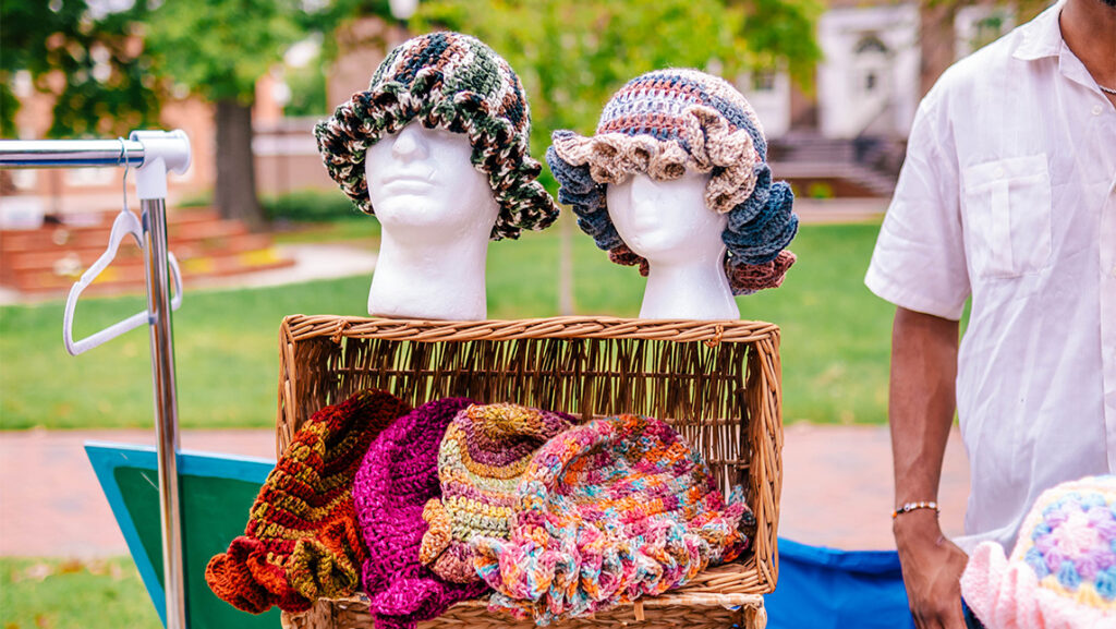 Crocheted hats are for sale at the UNCG student market.