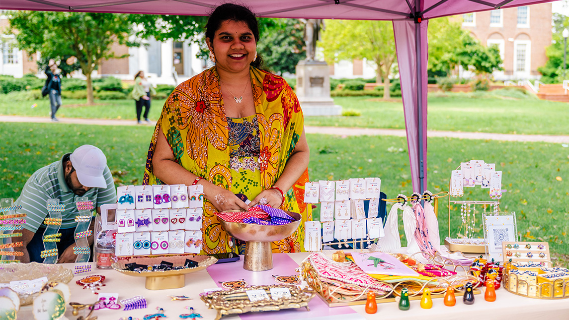 UNCG student Lakshmi Bobbili shows off a table of jewelry and ornaments.